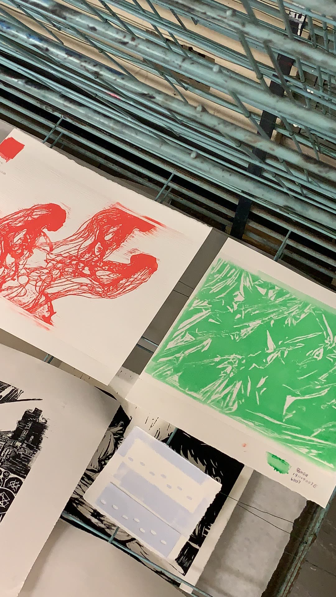 Green and red prints installed on studio wall