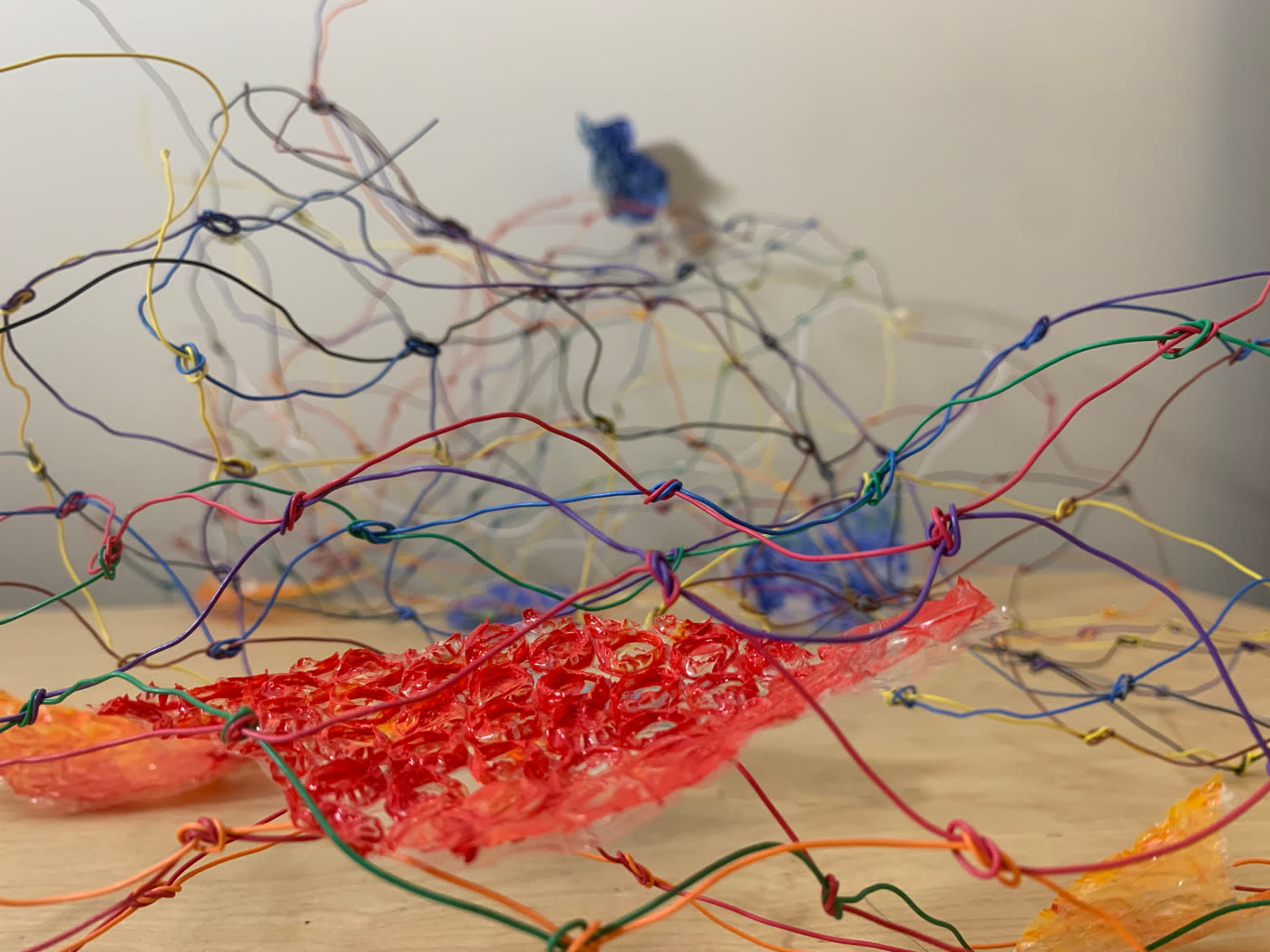 Wire sculpture detail, red thread
